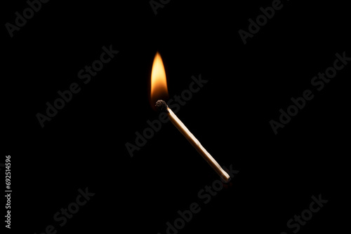 Lit falling match on a black background.