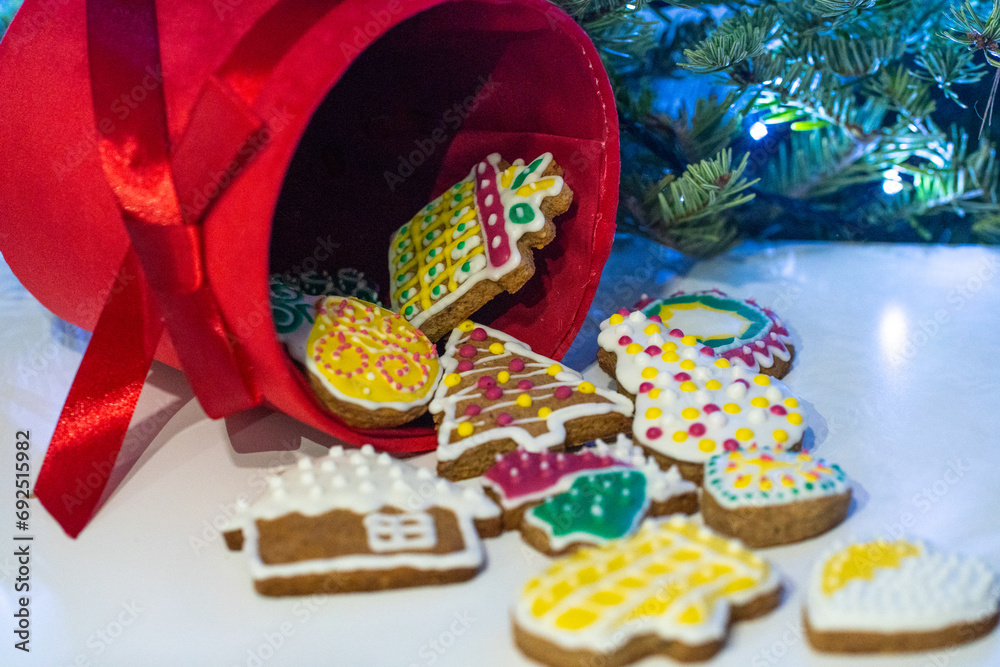 Gingerbread cookies in a red box on the background of a Christmas tree