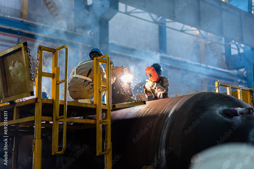 Workers are welding in the factory
