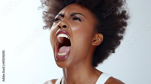 black woman is yelling with a fully open mouth photo