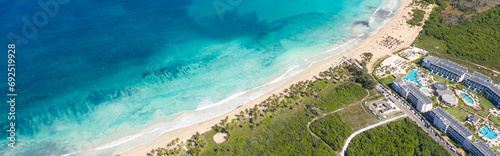Macao beach with sandy coastline, turquoise water and stone cliff. Famous seashore for surfing in Dominican Republic. Aerial drone view . Long banner photo