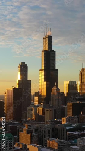 Urban Cityscape of Chicago Loop at Sunset in Frosty Winter Evening. Golden Hour. Aerial View. United States of America. Drone Flies Sideways. Medium Shot. Vertical Video