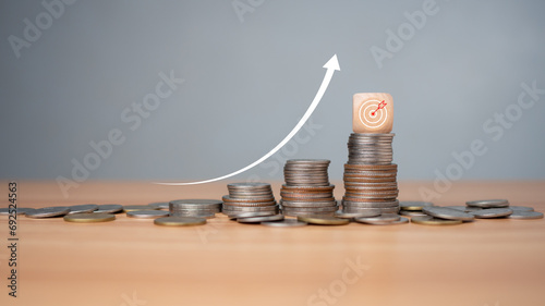 Inflation concept, white graph arrow, world economics, and inflation control, Money and budget management, dart board on a wooden cube with row of coins in idea for FED consider interest rate hike.