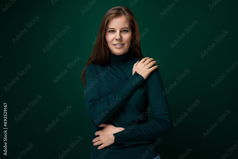 A 30-year-old slender woman with model appearance is wearing a green turtleneck A 30-year-old slender woman with model appearance is wearing a green turtleneck
