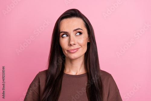 Photo of pensive minded gorgeous girl look interested empty space brainstorming isolated on pink color background
