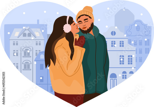 Beautiful romantic couple hugging on heart shaped background. Man and woman in winter clothes. Christmas time romantic activities.