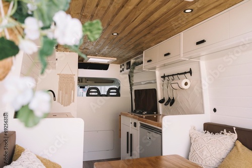 
Camper van interior made of wood in a traditional way and Nordic style.
Interior of a cozy motorhome designed in wood and decorated in earth tones.