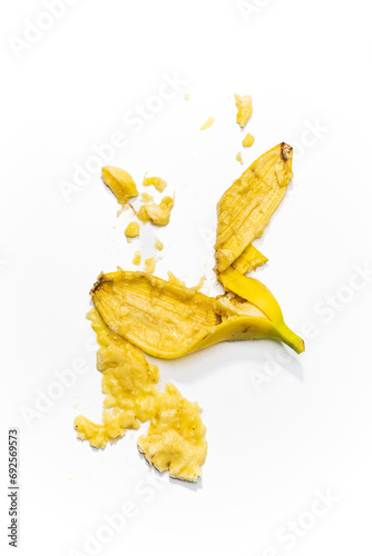 A smashed banana with peel against a white background photo