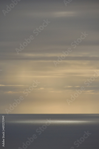 peaceful calmness and lightness at sunset with clouds over the sea photo