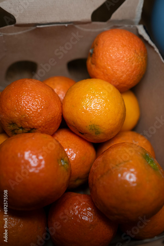 orange tangerines in a paper box