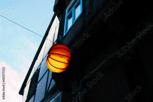 orange light hanging on wire © Stadtrandfoto