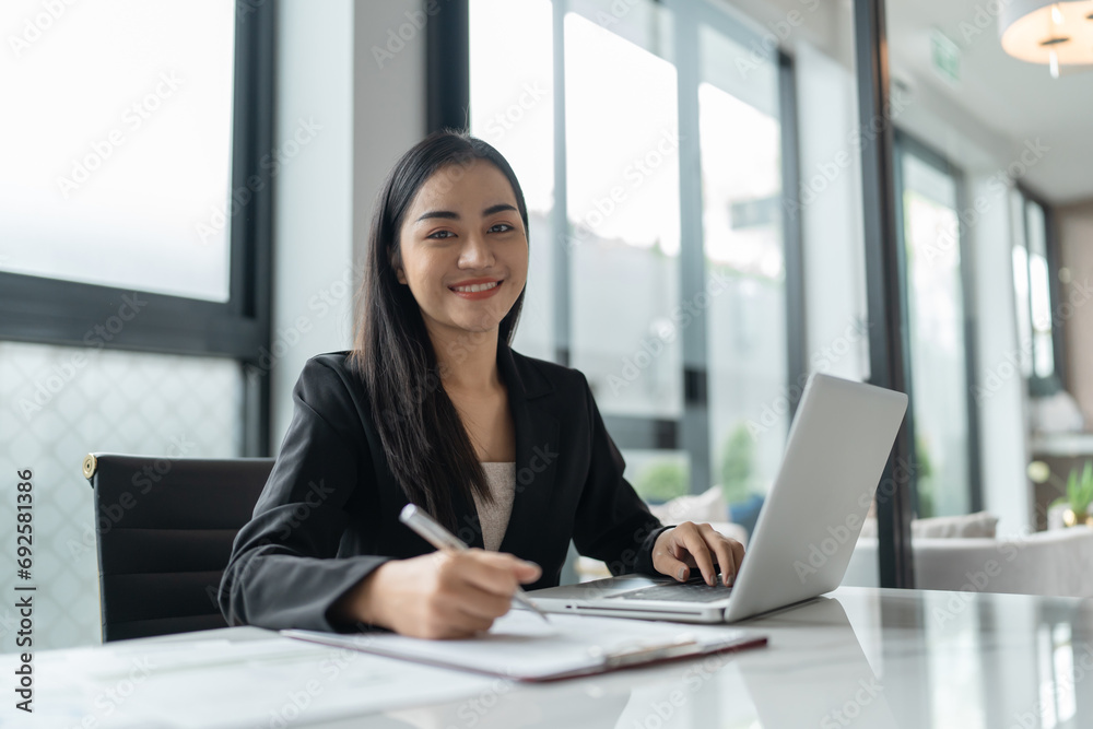 Beautiful Business Woman working by using laptop computer Hands typing on keyboard. Professional investor working new start up project. business planning in office. Technology business Concept Beautiful Business Woman working by using laptop computer Hands typing on keyboard. Professional investor working new start up project. business planning in office. Technology business Concept