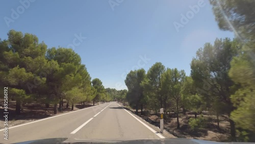 First person view, FPV, from dashcam of car driving mountain road from Calar Alto Observatory to Tabernas Desert in Almeria, Andalusia, Spain, Europe. Road trip in POV, with bright, sunny, clear sky photo