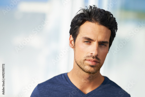 Man, portrait and fashion confidence or wall background in home in casual outfit, relax weekend or rest holiday. Male person, face and clothes or style trends or vacation, wellness or mockup space