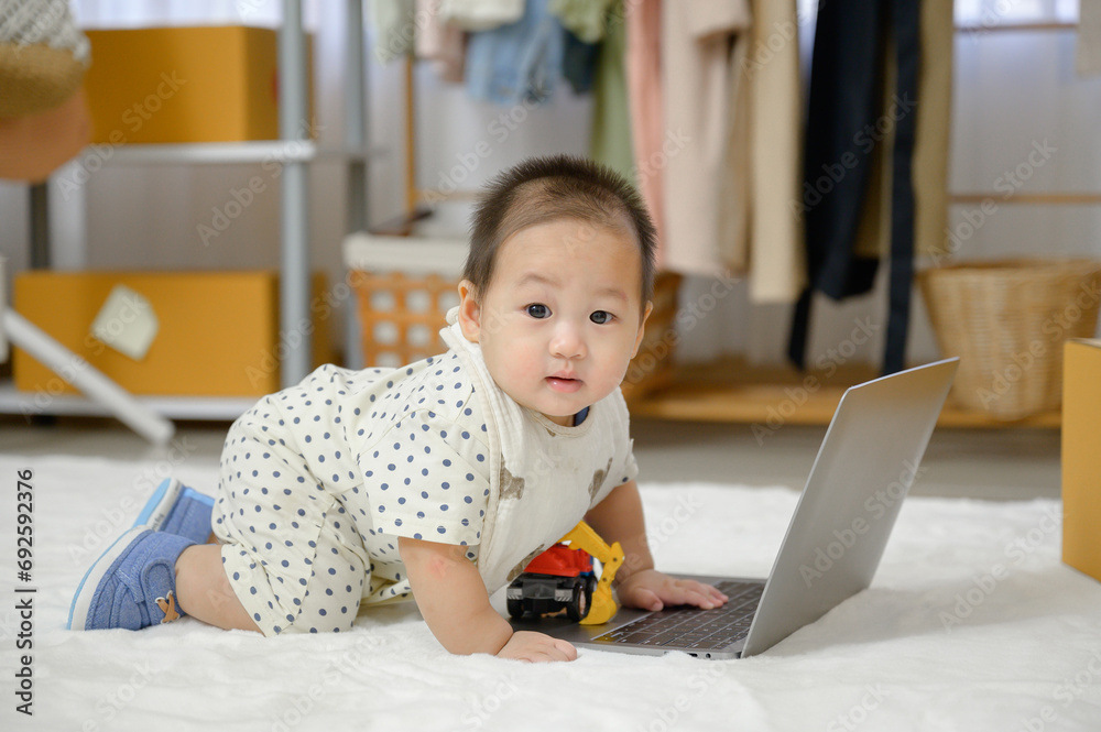 Asian baby boy Crawling on the carpeted floor in the living room and baby looking at the camera and playing alone in the room at home. Asian baby boy Crawling on the carpeted floor in the living room and baby looking at the camera and playing alone in the room at home.