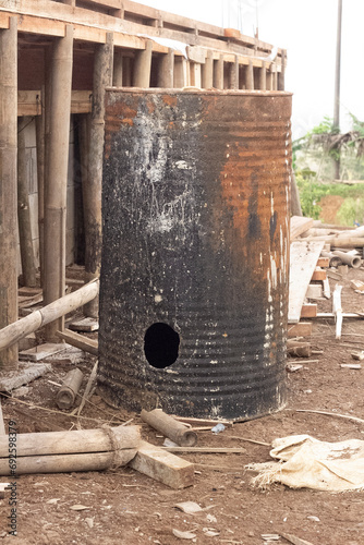 shabby iron barrel to acommodate water for cosntruction in indonesia photo
