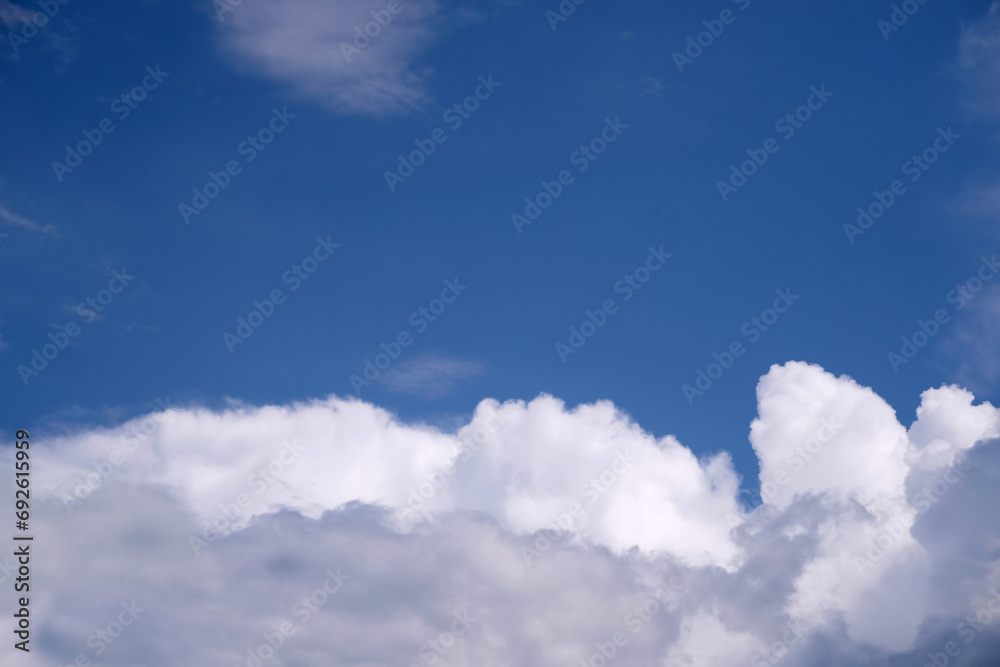 Beautiful landscape with blue sky and many dense white clouds on the bottom of the photo on bright sunny day Beautiful landscape with blue sky and many dense white clouds on the bottom of the photo on bright sunny day