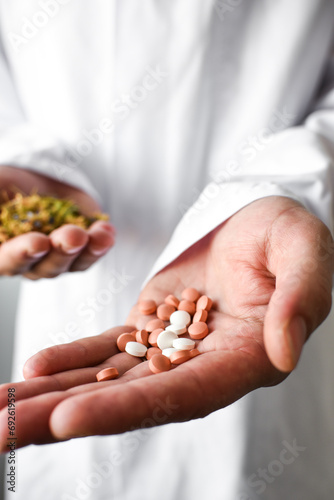 Herbs and synthetic medicine in doctor's hands