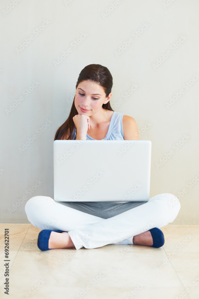 Woman, laptop and thinking for idea, decision or choice sitting against a wall at home. Female person freelancer in wonder, thought or planning for online research or communication on floor at house Woman, laptop and thinking for idea, decision or choice sitting against a wall at home. Female person freelancer in wonder, thought or planning for online research or communication on floor at house