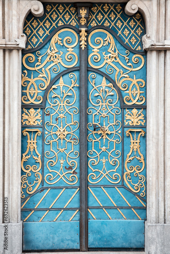 Vintage old blue door with a gold ornament