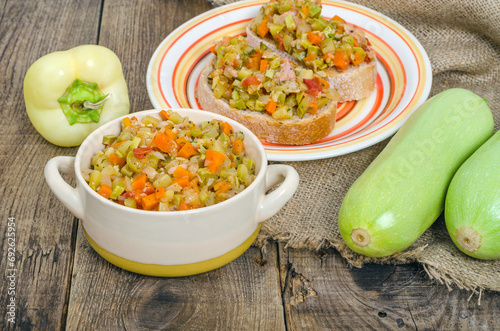 Bowl with vegetable stew and bread served on a table