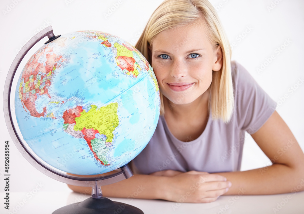 Portrait, smile and globe for travel with a woman in studio on a white background for holiday destination. Face, earth or planet with a happy young person looking at a location for world vacation Portrait, smile and globe for travel with a woman in studio on a white background for holiday destination. Face, earth or planet with a happy young person looking at a location for world vacation