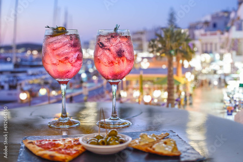 pink colorful aperitif with appetizers in a Mediterranean setting