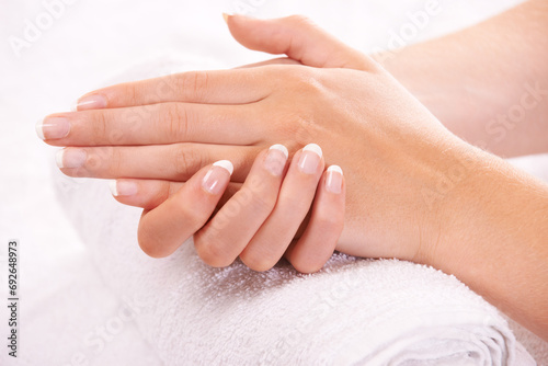 Woman, hands and french manicure in spa, salon and cosmetic care, skincare and beauty. Natural tips, wellness and treatment for hygiene, closeup and nail parlour with towel, clean and maintenance