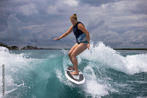 woman surfing on a boat wake