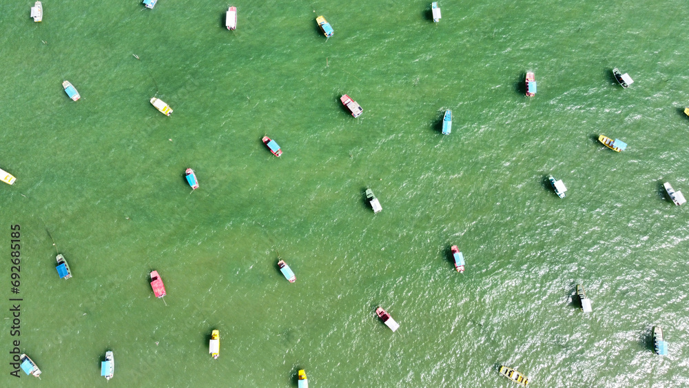Fototapeta premium Colorful boats floating on the water in San Miguel de Milagres in Brazil.
