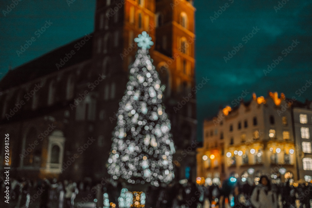 Stylish christmas golden illumination and Christmas tree. Krakow, Poland, Main Square and Cloth Hall in the winter season, during Christmas fairs decorated with Christmas tree.