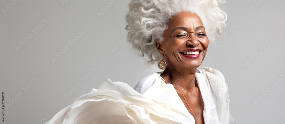 Portrait of very beautiful aged black woman with grey hair sliming to camera.