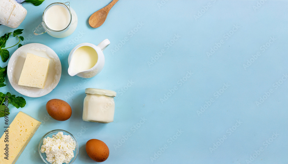 Fototapeta premium assorted dairy products on wooden table, natural lighting. Caption space.