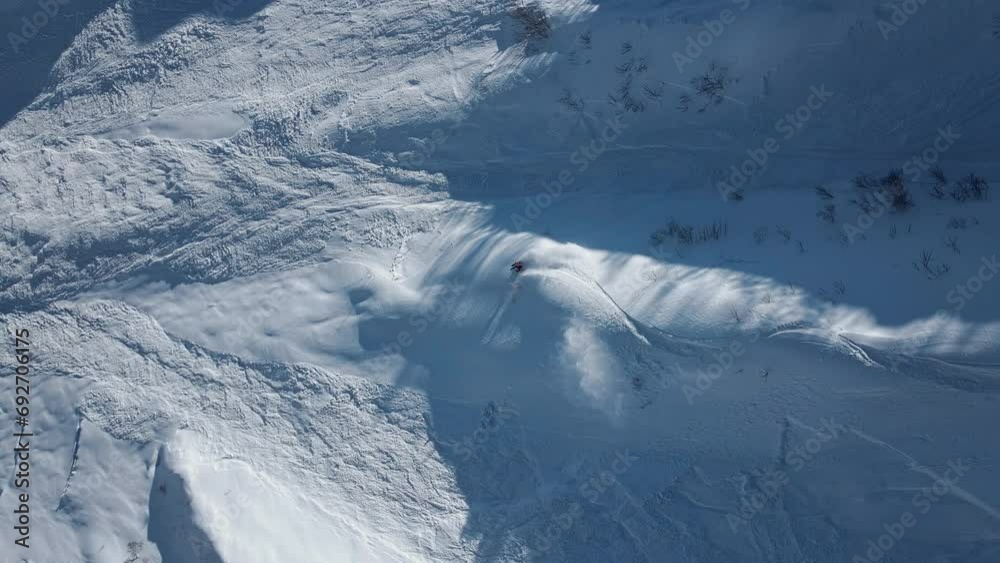 Aerial: A skier descends at high speed down an unprepared slope
