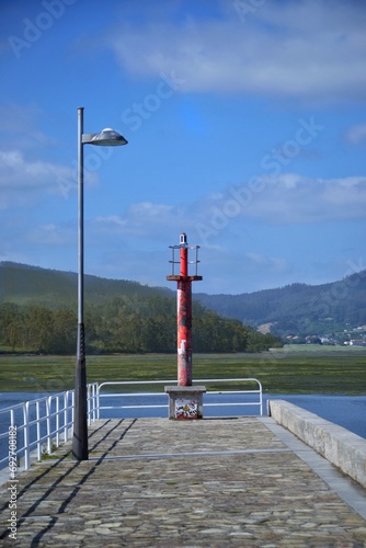 very small lighthouse advising the boats in a lake