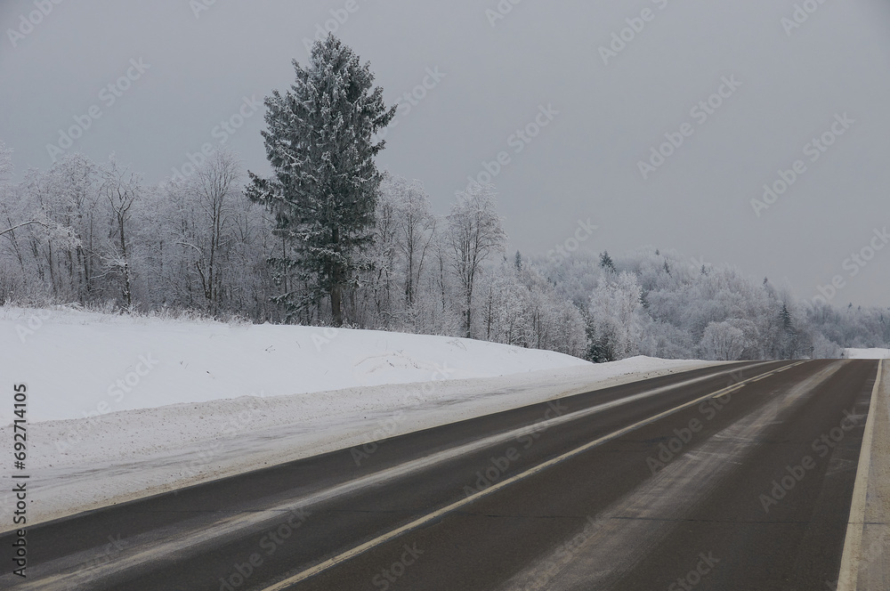 Snowy northern asphalt road, landscape Snowy northern asphalt road, landscape