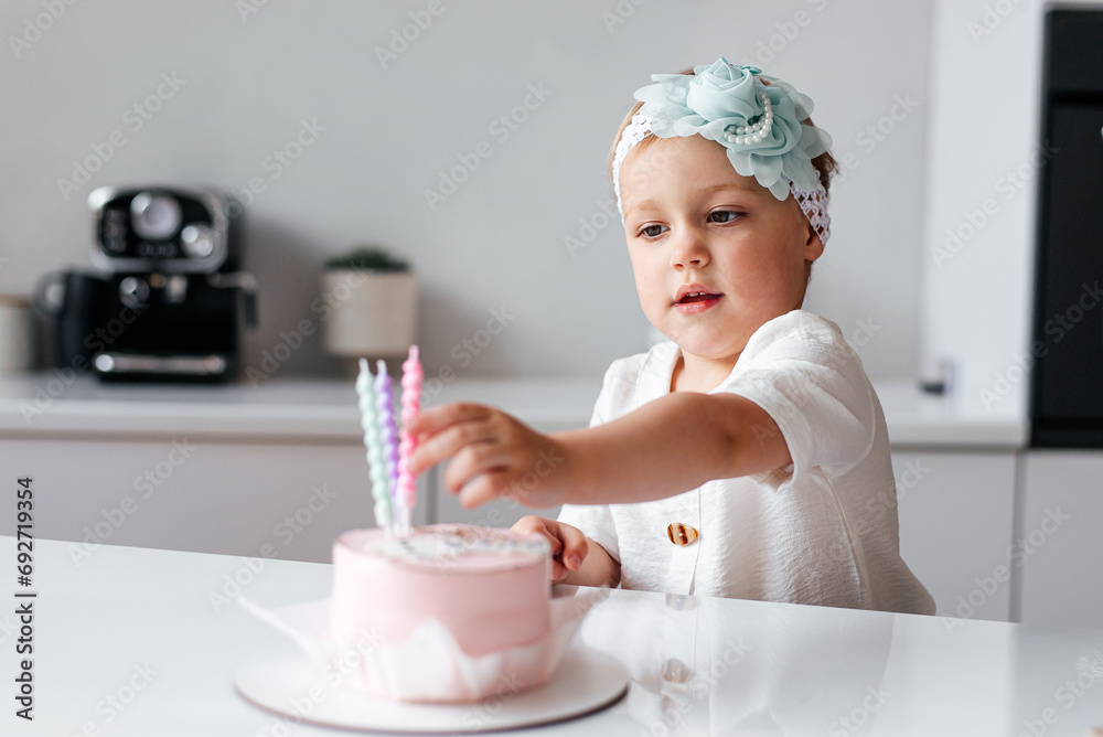 Three Years Old Girl Blowing the Candle on her Birthday Cake. Child celebrating her anniversary with homemade cake Three Years Old Girl Blowing the Candle on her Birthday Cake. Child celebrating her anniversary with homemade cake