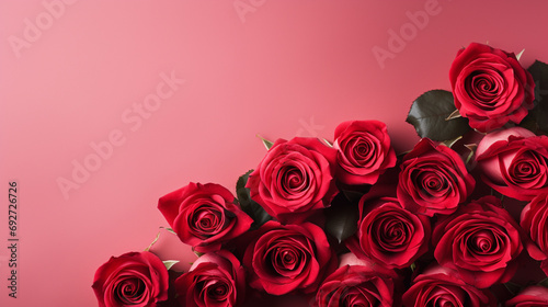 Serene top view of red roses carefully arranged on a pastel red backdrop  providing a delightful and visually appealing image with copyspace