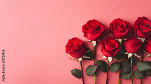 Serene top view of red roses carefully arranged on a pastel red backdrop  providing a delightful and visually appealing image with copyspace  
