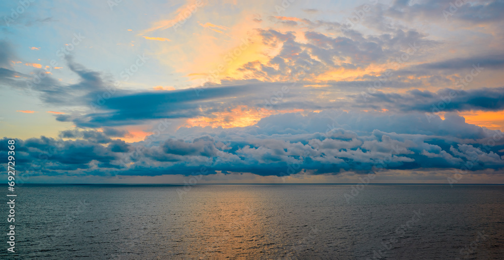 Beautiful colorful cloudy sunset seascape for sky replacement purposes