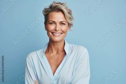 Portrait of happy middle aged woman with short blond hair smiling at camera