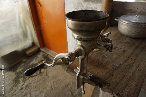Traditional coffee mill attached to a wooden table on a coffee farm close to Salento, Eje Cafetero, Colombia photo