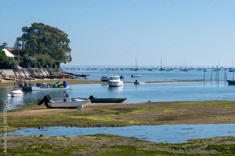 Beach houses in Arcachon Bay with many fisherman's boats and oysters farms, Cap Ferret peninsula, France, southwest of Bordeaux along France's Atlantic coastline Beach houses in Arcachon Bay with many fisherman's boats and oysters farms, Cap Ferret peninsula, France, southwest of Bordeaux along France's Atlantic coastline