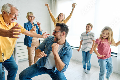 child family woman mother man father grandmother dancing music daughter group happy girl grandparent generation  grandchild together senior grandfather