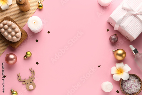 Composition with spa accessories, Christmas decorations and gift box on pink background photo