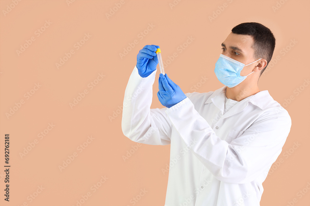 Male doctor in medical mask with test tube on beige background Male doctor in medical mask with test tube on beige background