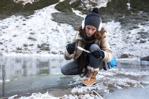Environment Expertise Woman Collecting Samples of Frost from Frozen Lake Environment in High Mountains of European Alps