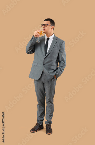 Young businessman drinking ...