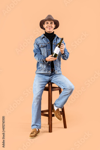 Young man with bottle of wi...