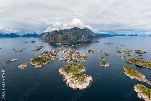 Aerial view, Henningsvaer with football pitch, rocky islands in the sea off Bergen, Festvagtinden, Vestvagoy, Lofoten, Norway, Europe photo